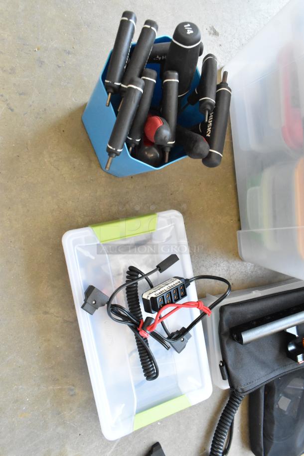 Lot of various items including a Movi Pro Pop-n-Lock, tools in blue bins, and cables in a clear poly bin.