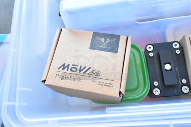 Lot of various items including Movi Pro Pop-n Lock with packaging, and bins stored in a clear poly bin.