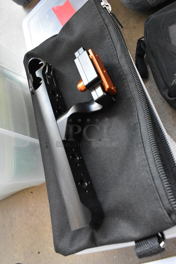 Lot including Movi Pro Pop-n Lock, shown in black fabric case, alongside clear storage bins.