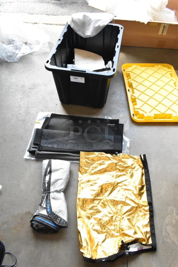 Hard poly bin with Westcott fabric contents, including black and gold fabric sheets, label "243," yellow lid beside.