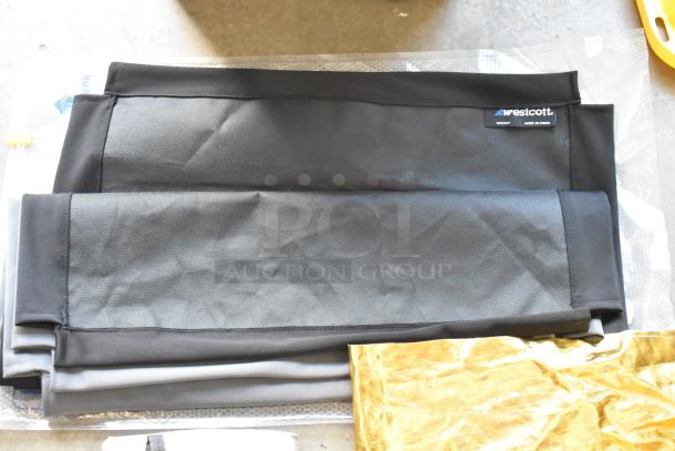 Hard poly bin contents including folded Westcott fabric in black with visible brand label.