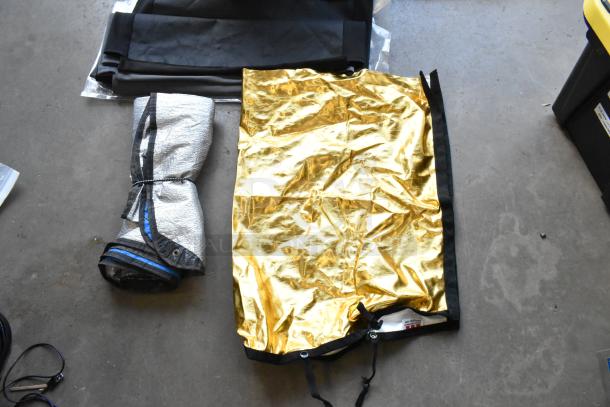 Hard poly bin contents, including Westcott fabric. Features gold and silver reflectors, folded black material. Used condition.
