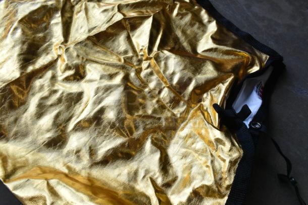 Hard poly bin filled with shiny gold Westcott fabric, in good condition; black trim visible.