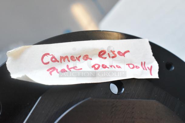 Dana Dolly Camera Riser with handwritten label, showing its purpose as a camera elevation tool for dolly systems.