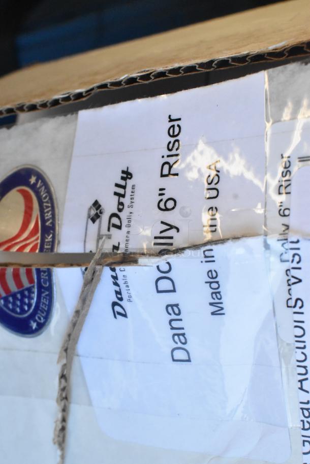 Dana Dolly Camera Riser packaging with label showing "Dana Dolly 6" Riser" and "Made in the USA." Box appears intact.