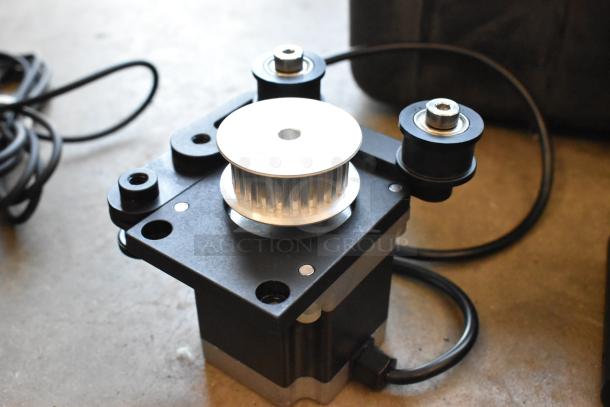 Alt text: Ditogear unit with pulley and wheel system in a hard case, part of a lot including modules, LensDrives, and Sony controller.
