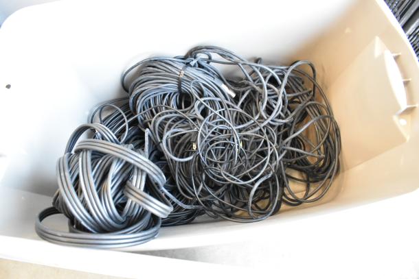 Lot of 3-pin XLR cables and component video cables in a beige poly bin. Cables appear coiled and in used condition.