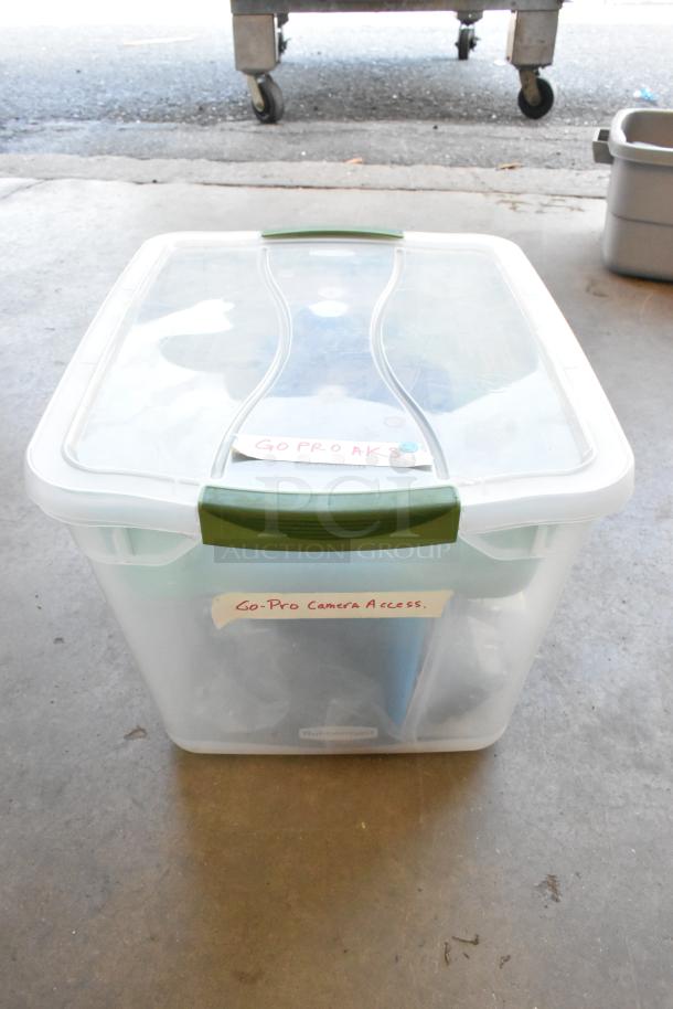 Poly bin containing GoPro accessories, wires, and poly containers. Lid labeled "GoPro AKS" and side marked "Go-Pro Camera Access."