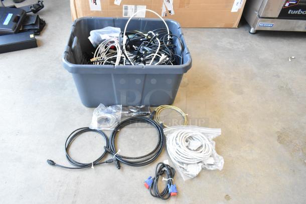 Poly bin filled with assorted wires, cables, and connectors. Various lengths and types. Some items in plastic bags.