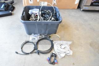 Poly bin filled with assorted wires, cables, and connectors. Various lengths and types. Some items in plastic bags.