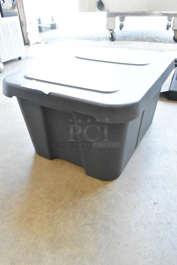 Poly bin containing various items, including wires. Durable storage solution. Good condition. Ideal for multiple uses.