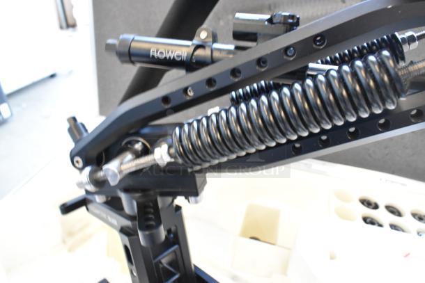 Flowcine Black Mount with visible coil springs, in excellent condition, housed in a foam-padded hard case.