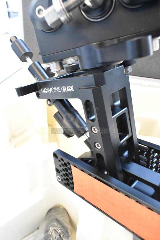 Flowcine Black Mount in hard case, features sturdy black metal construction with visible branding on the side, in excellent condition.