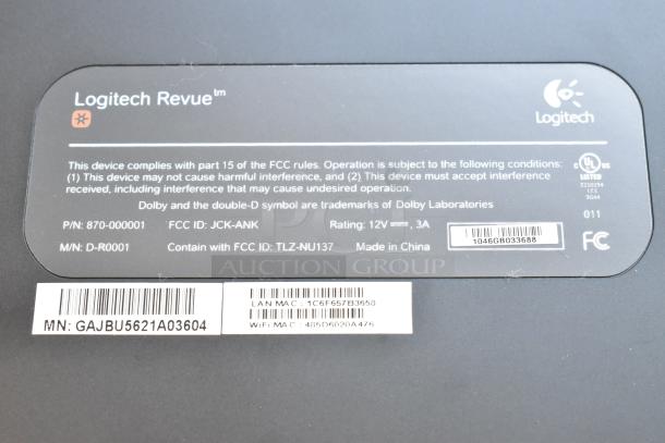 Logitech Revue Media Player label showing model D-R0001, FCC compliance, power rating, and manufacturing details.