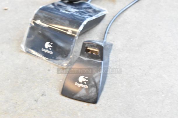 Logitech Revue Media Player connectors with logo, showing USB port, on a gray surface.