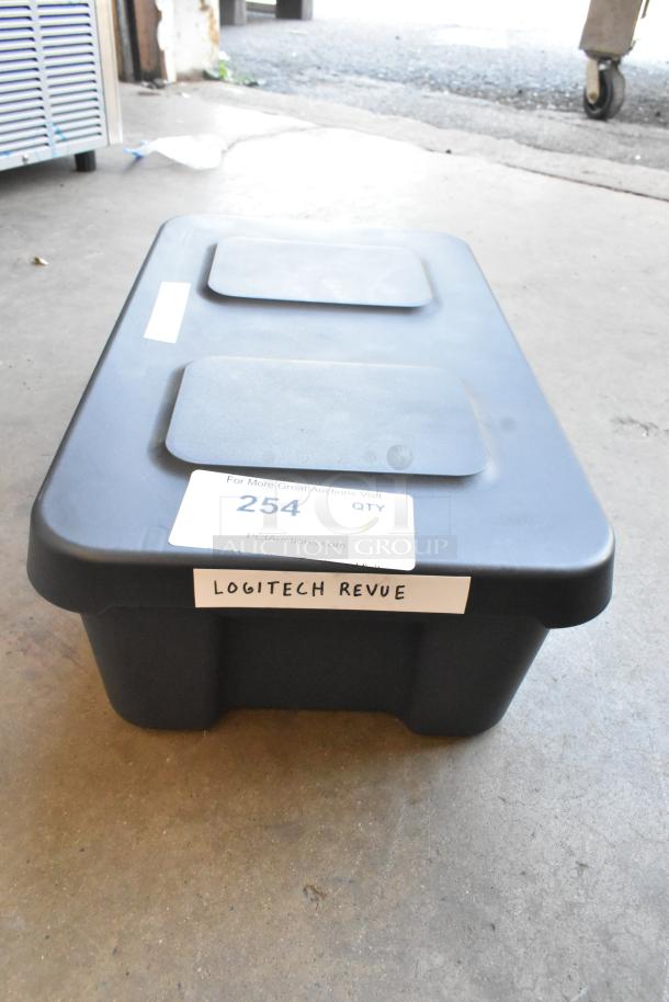 Logitech Revue Media Player with Keyboard in black storage bin, labeled "Logitech Revue," condition unspecified.