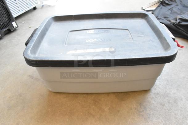 Poly bin containing a lot of Sylvania lightbulbs. The bin has a black lid marked "Roughneck." Used condition.