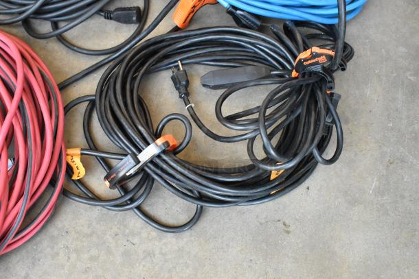 Lot of assorted extension cords in a poly bin, multiple colors, good condition, includes labels and cable management clips.