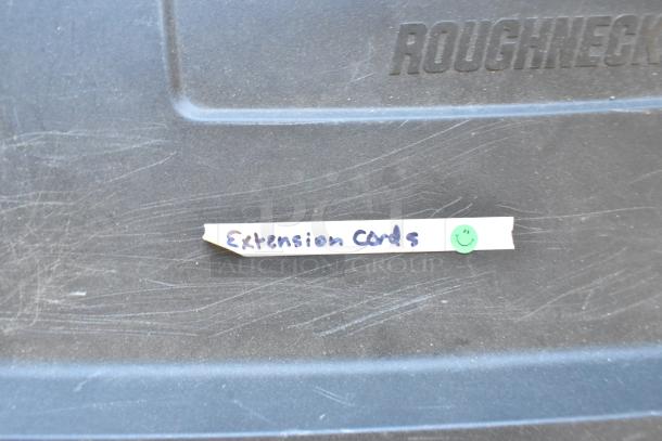 Poly bin filled with various extension cords, labeled "Extension Cords" with a smiley face sticker, minor scratches visible.