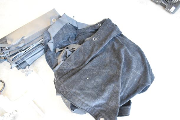 Lot of various items including a square stock metal holder, dark fabric with grommets, and poly bin. Mixed condition.
