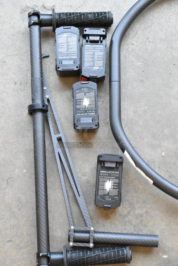 Movi Ring with three battery packs on concrete. Carbon fiber build, textured grips. Batteries labeled "14.8V, 2.6Ah."