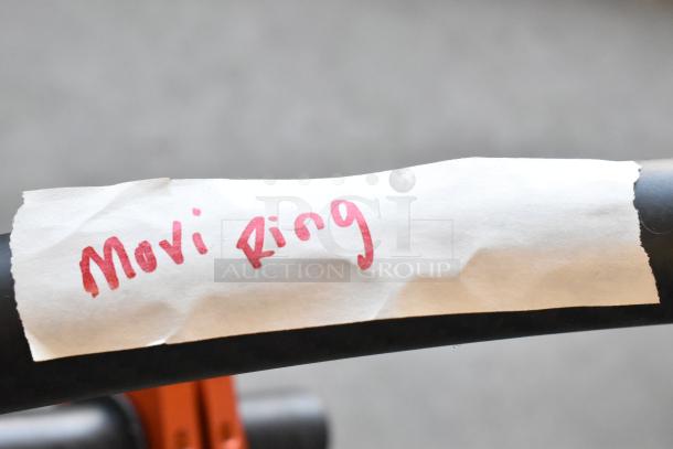 Movi Ring with handwritten label, includes batteries; features a durable design for enhanced camera stabilization.