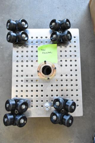Movi Elevator with metal perforated plate and rubber wheels, in good condition. Green label marked "Movi Elevator."
