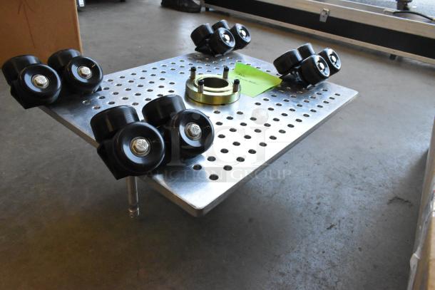 Movi Elevator with perforated metal platform, black caster wheels, and central mounting hub. Excellent condition.