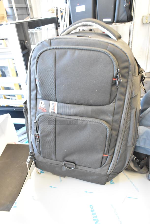 Two bags, including a Petrol DSLR backpack with logo, black color, multiple compartments, and zippers; good condition.
