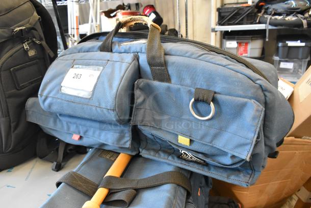 Two bags featuring a Petrol bag and a Porta Brace bag. Blue fabric, sturdy handles, exterior pockets. Visible label: "263 QTY."