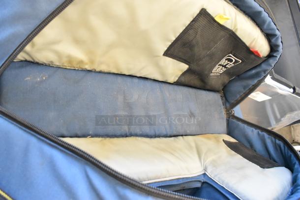 Two bags including a blue Porta Brace bag with visible wear, interior padding, and logo tag. One additional unidentified bag.