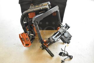 Digi Ignite metal frame with carbon fiber construction in a rolling bag. Includes various mounts and a Porta Brace case.