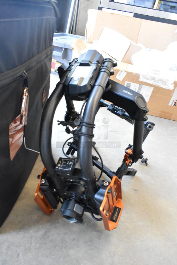 Digi Ignite metal frame in excellent condition, folded, with orange accents, stored in rolling bag for transport.