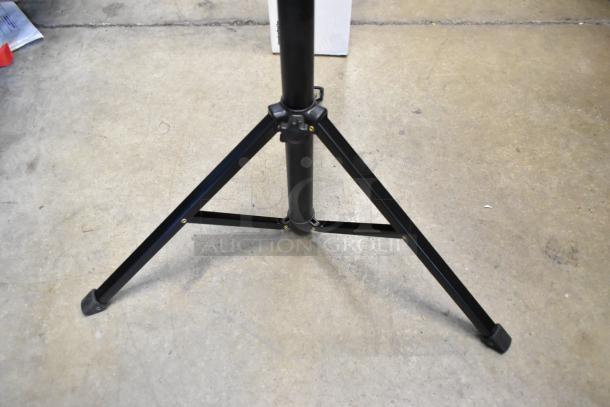Chimera Tripod with black metal legs, shown on a concrete floor, in good condition.