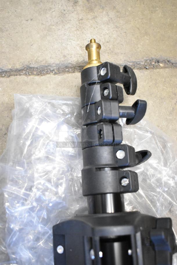 Two Westcott Basics stands, featuring adjustable height clamps and brass mounts, in excellent condition.