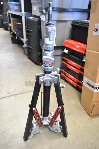 Matthews tripod with sturdy silver and black metal construction, three adjustable legs, and “Matthews Studio Equipment” label.