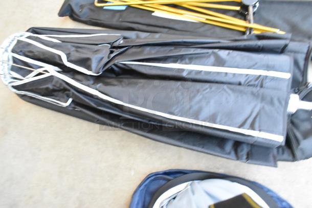 Black fabric umbrella with light gear holder, metal frame, and foldable design, indicating moderate use; no visible brand markings.