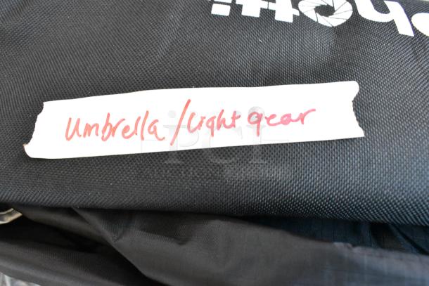 Umbrella/light gear with black fabric holder, labeled in red cursive. Suitable for photography lighting.