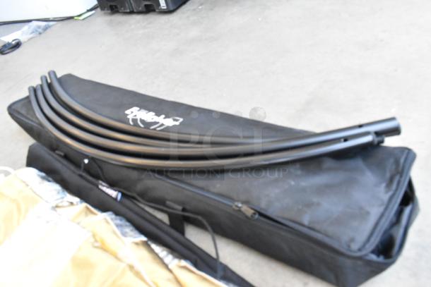 Umbrella/light gear set with fabric holder, includes black carrying case. Used condition, brand logo visible on case.
