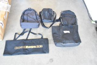 Lot of 4 soft bags: two backpacks, one tote-style bag, and a RoadRags II carrying bag. All bags appear in good condition.