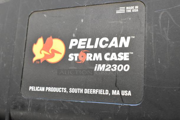 Pelican Storm Case iM2300, black, sturdy construction, label shows brand and model, made in USA, slight wear visible.