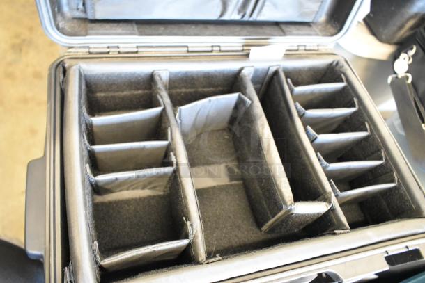 Pelican Storm Case iM2300 with customizable padded compartments, shown open. Rugged and durable, excellent condition.