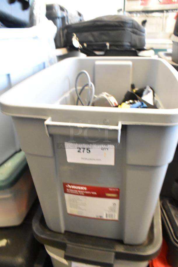 Lot of ratchet straps in a gray poly bin with Husky label, item number 275. Mixed condition suggests various use levels.
