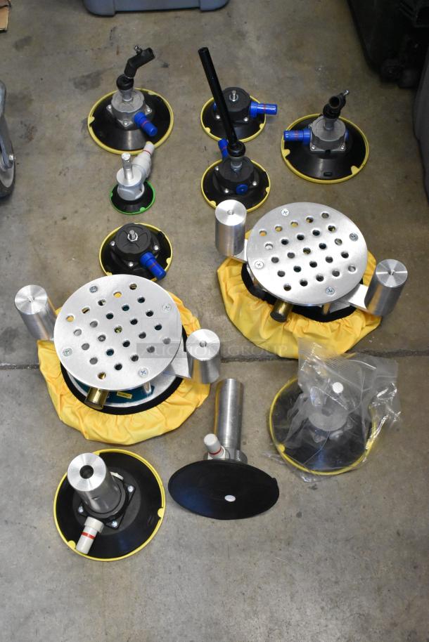 Lot of metal pieces in poly bin; includes round metal bases, yellow accents, valves, good condition.