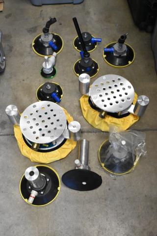 Lot of metal pieces in poly bin; includes round metal bases, yellow accents, valves, good condition.