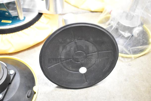 Lot of metal pieces in poly bin, featuring circular black metal plates and machinery parts. Condition appears used.