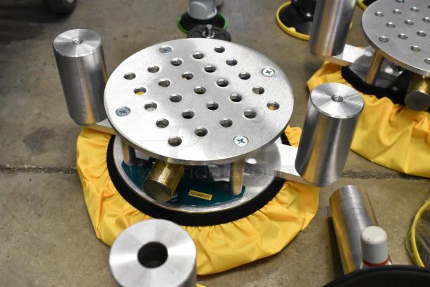 Lot of various metal pieces in a poly bin, including circular perforated discs and cylindrical components. Marking: N2386623.