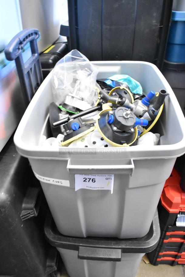 Poly bin filled with assorted metal pieces, auction lot number 276, labeled "Suction Cups," in used condition.