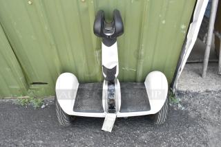 Segway N4M350 self-balancing scooter in durable hard case, white with black accents, minor wear visible.