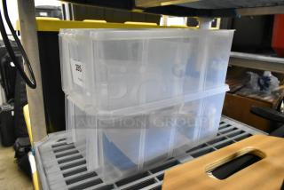 Clear poly bins, stackable, labeled "285," in excellent condition on a shelf. Auction: 2x your bid.